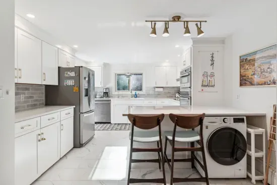 The fully renovated kitchen with wall oven and microwave, reverse osmosis drinking water, extra clothes washer, and dishwasher. Seating for 2 at the peninsula. Coffee provided!