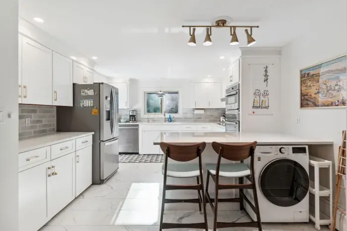 The fully renovated kitchen with wall oven and microwave, reverse osmosis drinking water, extra clothes washer, and dishwasher. Seating for 2 at the peninsula. Coffee provided!