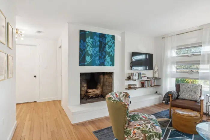The living room with 3 chairs, a comfy 3 seater couch, and smart TV! Please note - the fireplace is inoperable