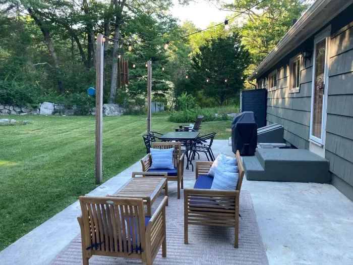 The backyard patio with plenty of seating and a gas grill!