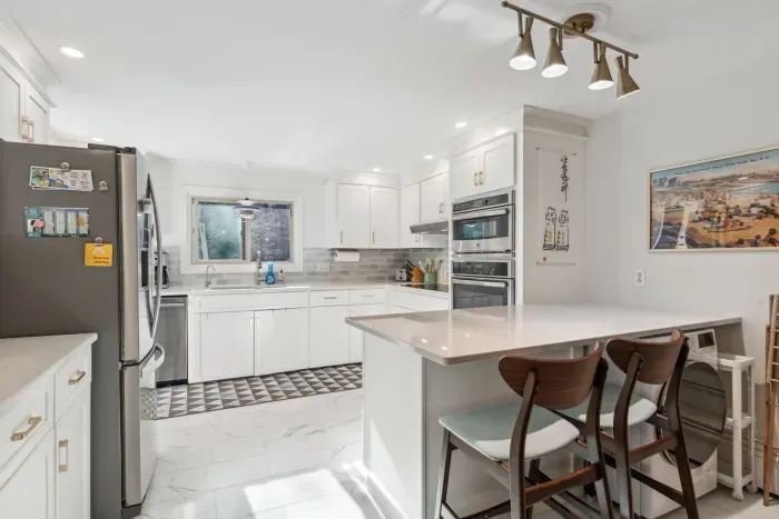 The fully renovated kitchen with wall oven and microwave, reverse osmosis drinking water, extra clothes washer, and dishwasher. Seating for 2 at the peninsula. Coffee provided!