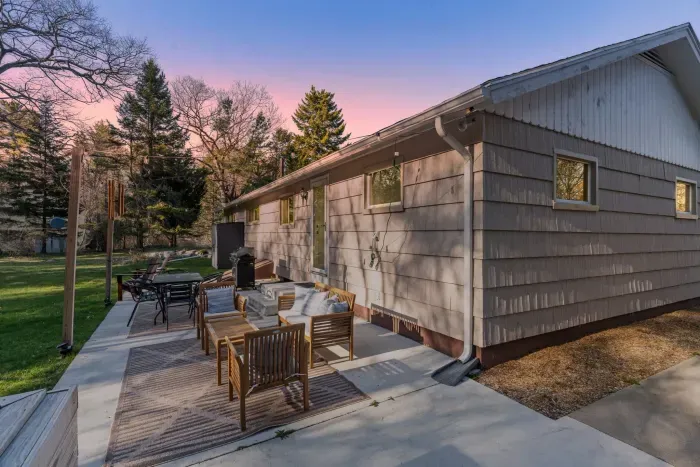 The backyard patio with plenty of seating and a gas grill!