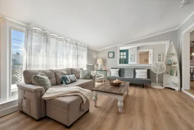 Spacious living room with sectional pull out sofa and 3-seater sofa. Note: fireplace is inoperable