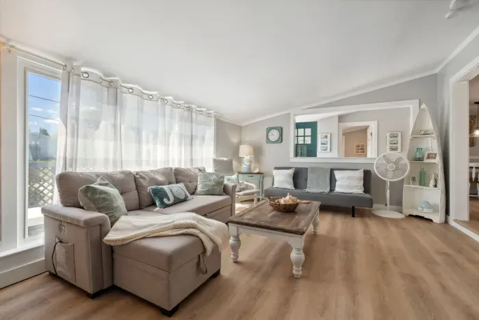 Spacious living room with sectional pull out sofa and 3-seater sofa. Note: fireplace is inoperable