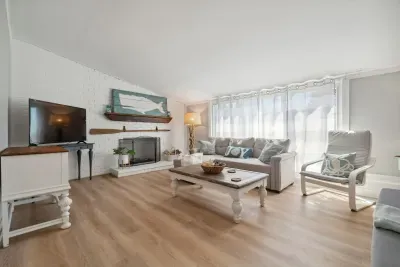 Spacious living room with sectional pull out sofa and 3-seater sofa. Note: fireplace is inoperable