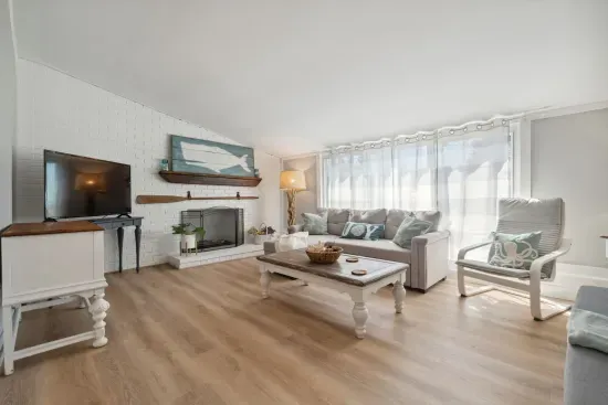 Spacious living room with sectional pull out sofa and 3-seater sofa. Note: fireplace is inoperable
