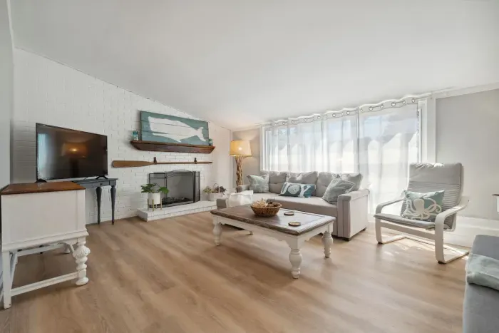 Spacious living room with sectional pull out sofa and 3-seater sofa. Note: fireplace is inoperable