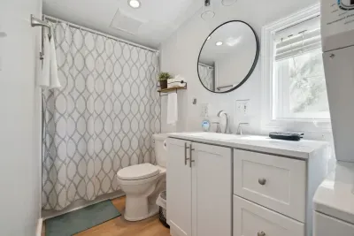 Sleek, minimal full bathroom with standing shower