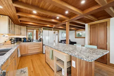 Open concept kitchen and living room with large windows to enjoy plenty of natural light.