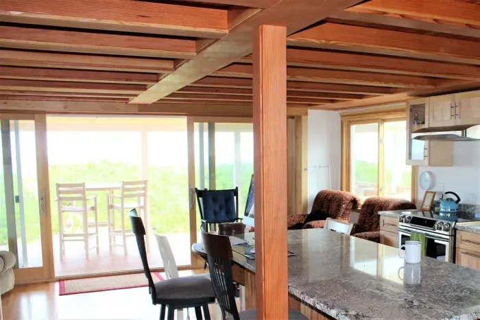 Open concept kitchen and living room with large windows to enjoy plenty of natural light.