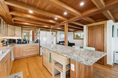 Open concept kitchen and living room with large windows to enjoy plenty of natural light.