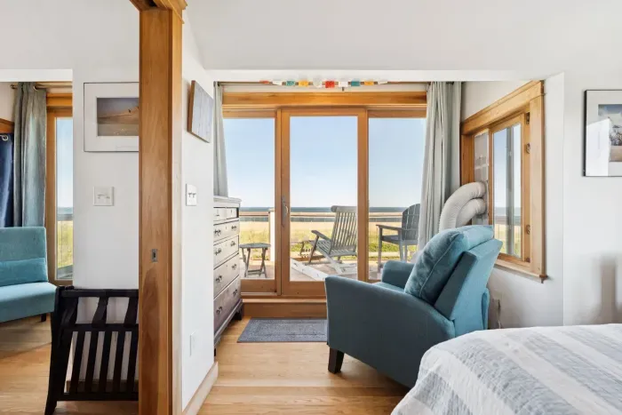 Master bedroom on 2nd floor with queen bed and balcony overlooking the ocean.