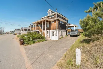 Front entrance of home from street with 4-car driveway on right-hand side of home.