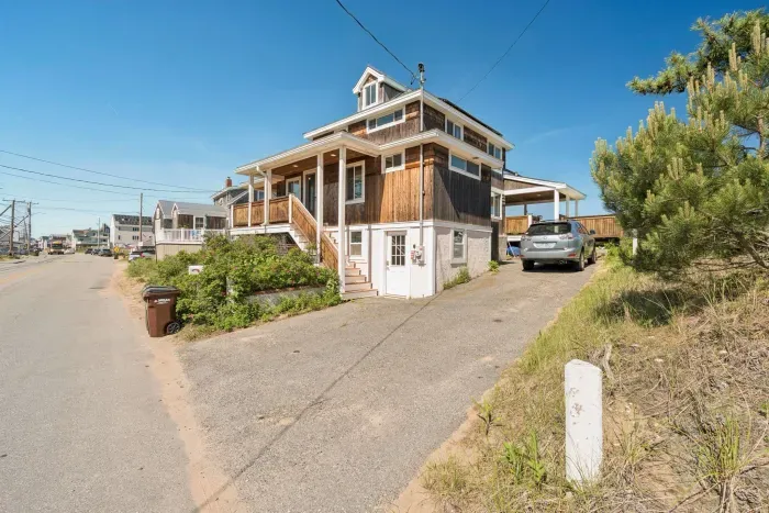 Front entrance of home from street with 4-car driveway on right-hand side of home.