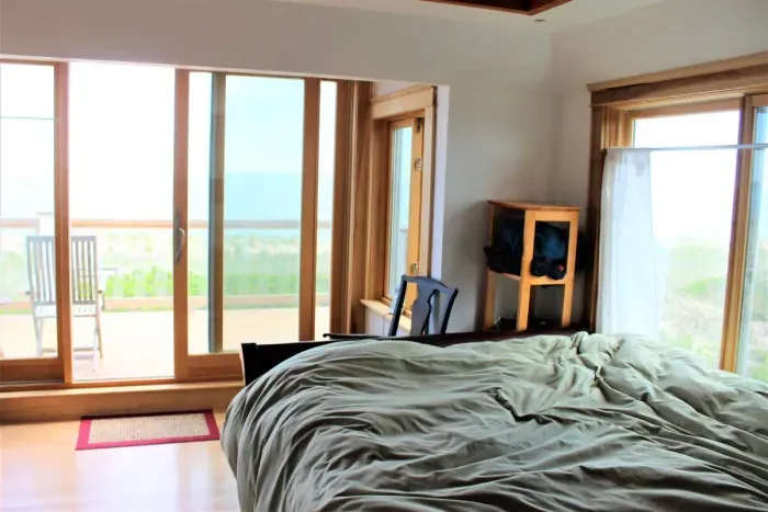 Master bedroom on 2nd floor with queen bed and balcony overlooking the ocean.