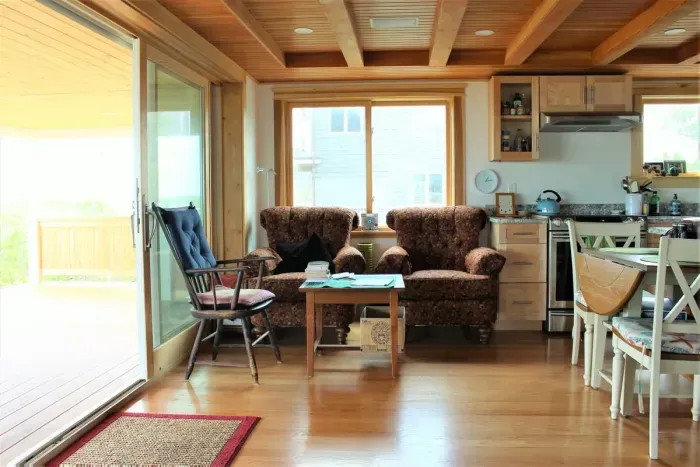 Open concept kitchen and living room with large windows to enjoy plenty of natural light.