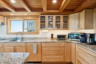Open concept kitchen and living room with large windows to enjoy plenty of natural light.