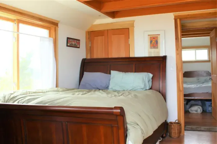 Master bedroom on 2nd floor with queen bed and balcony overlooking the ocean.