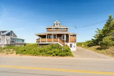 Front entrance of home from street with 4-car driveway on right-hand side of home.