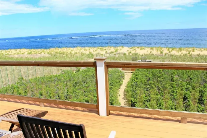 Master bedroom on 2nd floor with queen bed and balcony overlooking the ocean.
