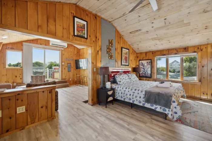 Kitchen area POV, the bedroom area has a ceiling fan, provided clean linens, and a smart TV!