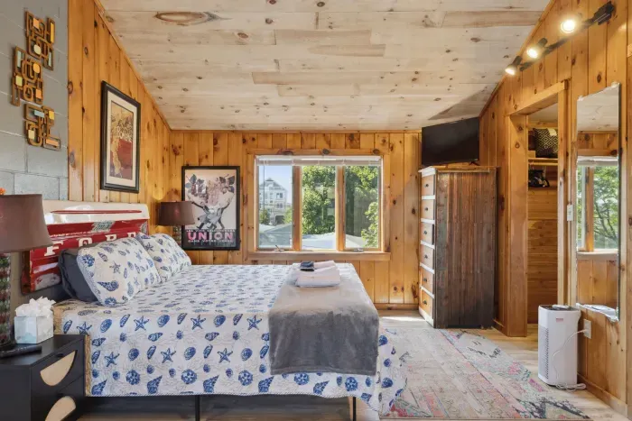 Bedroom area with smart TV, walk in closet, and king bed