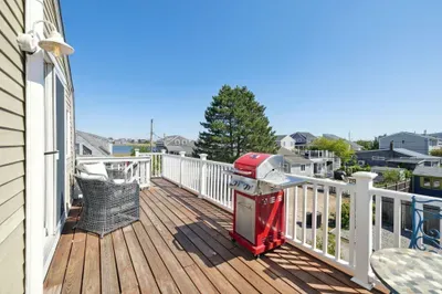 Plum Island basin views from the deck! Please note - the access to the unit is up the flight of stairs pictured in the photo at the end of the deck. Please see the walkthrough video for entry details.