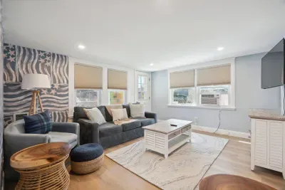 Professionally designed and super comfy! This family room has a smart Roku TV and seating for 4