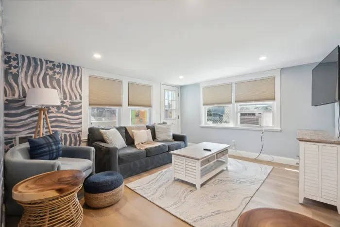 Professionally designed and super comfy! This family room has a smart Roku TV and seating for 4