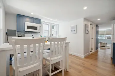 The newly renovated kitchen! New appliances and cabinets all around. This fully equipped kitchen has seating for 4 at the kitchen table (no dishwasher)