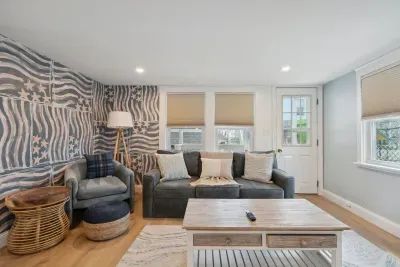 Professionally designed and super comfy! This family room has a smart Roku TV and seating for 4