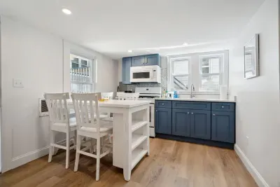 The newly renovated kitchen! New appliances and cabinets all around. This fully equipped kitchen has seating for 4 at the kitchen table (no dishwasher)