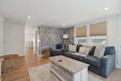 Professionally designed and super comfy! This family room has a smart Roku TV and seating for 4