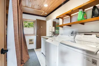 The laundry room! Washer and dryer are located here. There is access from the foyer, and there is also access via the garage as seen in the picture