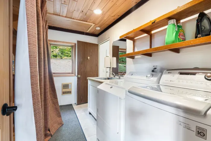 The laundry room! Washer and dryer are located here. There is access from the foyer, and there is also access via the garage as seen in the picture