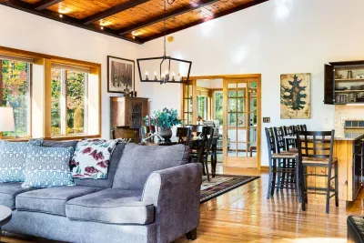 The great room with the comfy couch and the 8 person dining table and eat in kitchen!