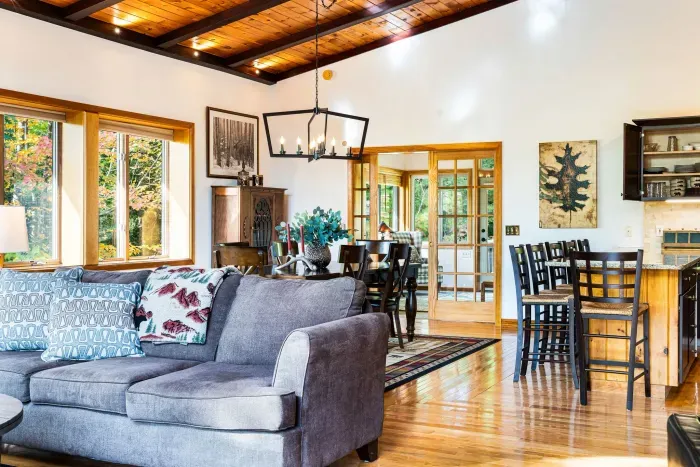 The great room with the comfy couch and the 8 person dining table and eat in kitchen!