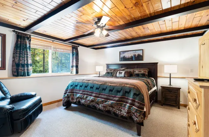 The primary bedroom, clean linens provided. There is a Roku smart TV not shown, to the left of the photo