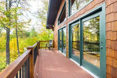 The balcony outside of the great room. With 2 Adirondack chairs and a slice of mountain views!