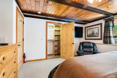 The primary bedroom with a Roku smart TV, massage chair, and ensuite. Clean linens provided!