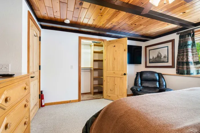 The primary bedroom with a Roku smart TV, massage chair, and ensuite. Clean linens provided!