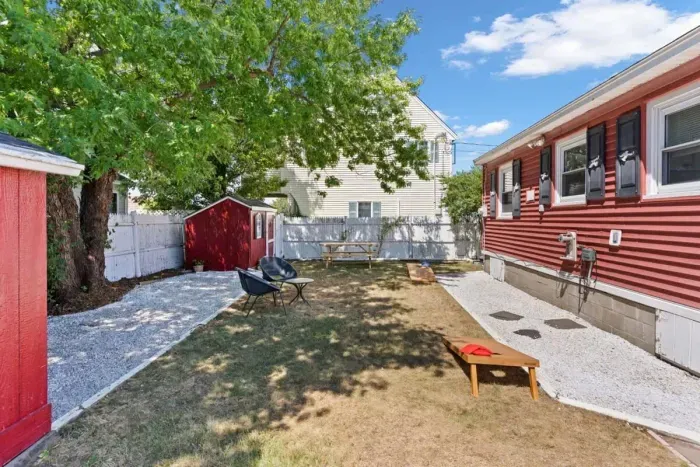 Fenced-in back yard, with lawn games, picnic table and gas grill perfect for relaxing.