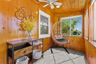 Front sun room with cushioned hanging chair