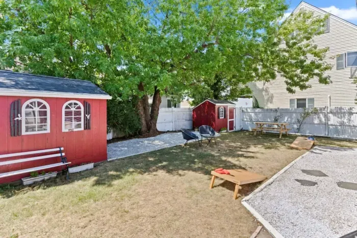 Fenced-in back yard, with lawn games, picnic table and gas grill perfect for relaxing.