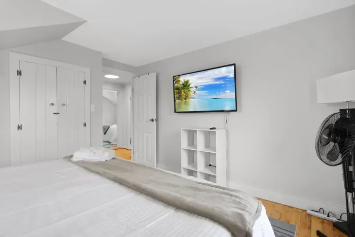 Primary bedroom with king bed and smart TV