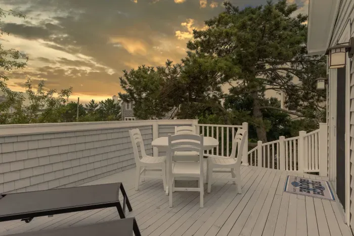 Spacious back deck with dining set and lounging chairs off the kitchen