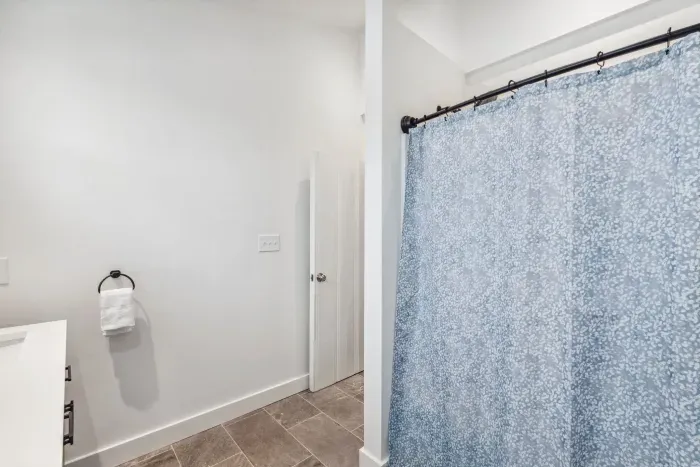 Fully renovated first floor bathroom with shower/tub combo and dual vanities. Clean towels provided for all guests