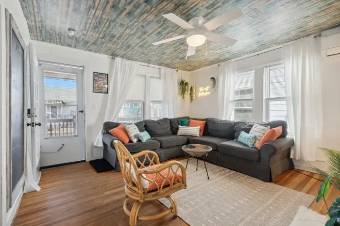 Cozy and comfortable living space with a brand new (spring 2022) wrap around sectional couch, 40” Samsung Smart TV, electric fireplace, and a central air temperature controlled mini-split system.