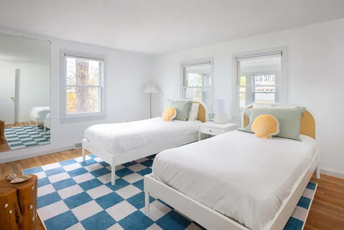 Cozy and comfortable—this bedroom features two single beds for a restful stay. Clean linens provided. 💤✨