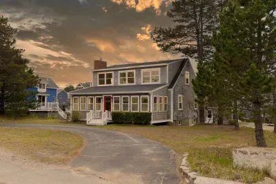 Welcome to Salt & Cedar - twilight edition! This home has two driveways, one pictured here and the other out behind the property